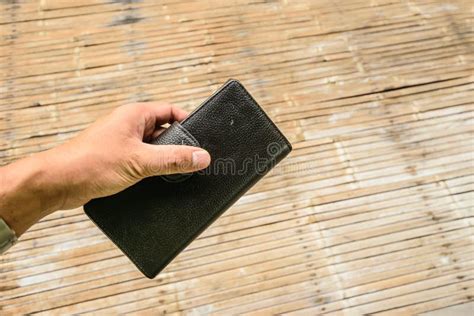 One Hand Holding A Black Leather Wallet Stock Photo Image Of Pulling