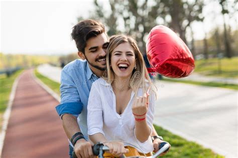 Young Loving Couple Dating While Riding Bicycles In The City Stock