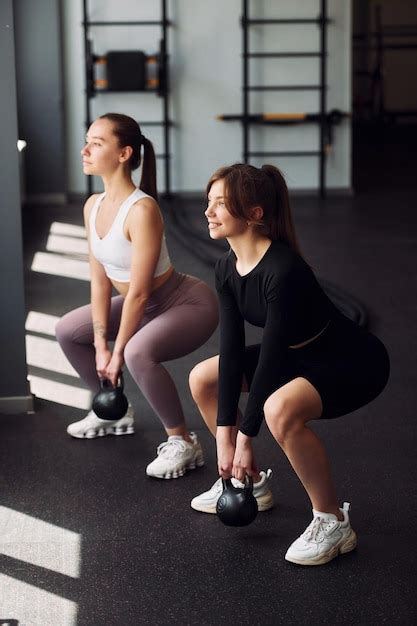 Premium Photo Lifting The Weights Two Women In Sportive Clothes Have