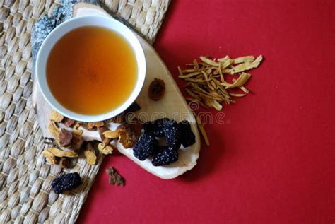 Bowl Of Chinese Herb Tea With Pieces Of Astragalus And Huang Qi Roots