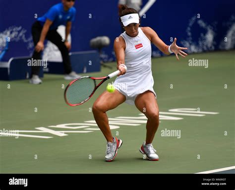 Wang Qiang Of China Returns A Shot To Magda Linette Of Poland In Their