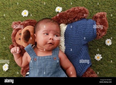 Newborn 3 Week Old Mixed Race Baby Boy Relaxing In The Garden With