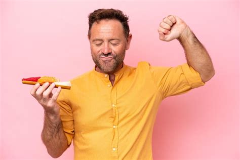 Hombre caucásico de mediana edad sosteniendo sashimi aislado de fondo