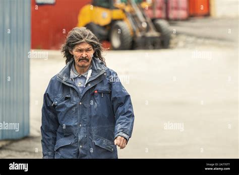 An Inuit local man walking going to work t the port of Nuuk, Greenland ...