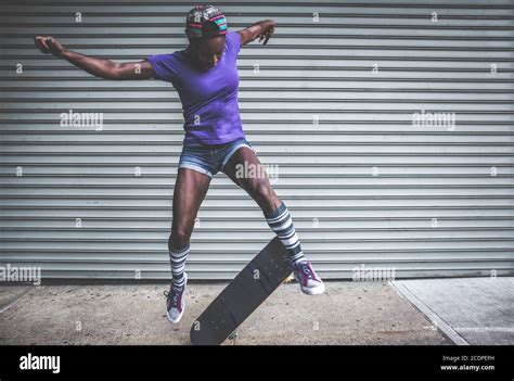 Young girl performing tricks with the skateboard Stock Photo - Alamy