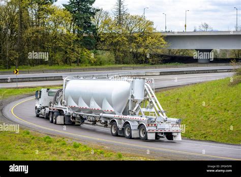 White Industrial Big Rig Day Cab Semi Truck Tractor Transporting Commercial Cargo In Conical