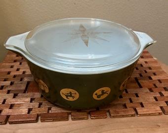 Vintage Pyrex Zodiac Casserole With Lid And Warming Cradle C