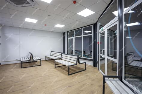 Premium Photo Waiting Room With Wooden Benches At A Train Station