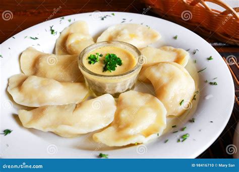 Ukrainian And Russian Dish Vareniki With Mashed Potatoes And Sour Cream