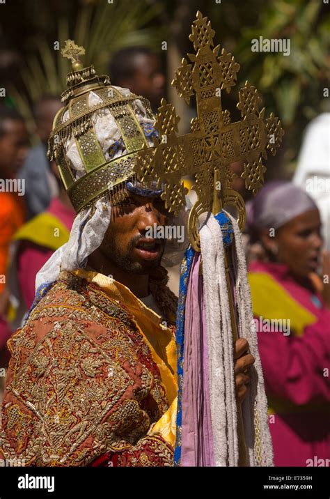 Ethiopian Orthodox Priest Holding A Cross During The Colorful Timkat