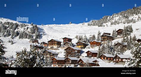 Swiss wooden chalets in the snow in winter in the Alps at the mountain ...