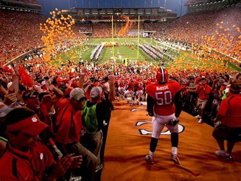 Download Clemson Tigers Football Team Entrance With Orange Balloons Wallpaper