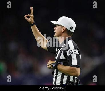 Referee Shawn Hochuli signals during an NFL football game between the ...