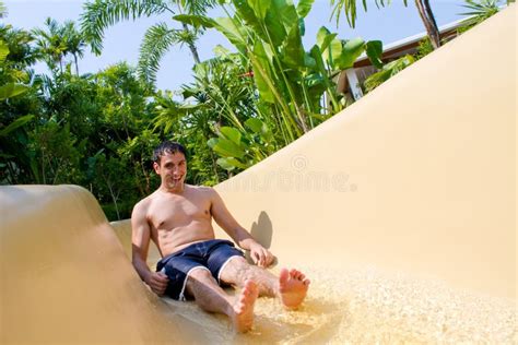 Father And Daughter Sliding Down Water Slide Stock Image Image Of