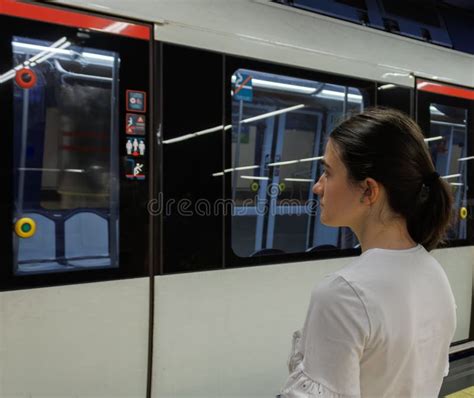 Woman Waiting For The Subway Doors To Open And Stop So She Can Get In