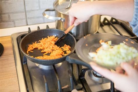 Premium Photo Carrot And Onion On Frying Pan