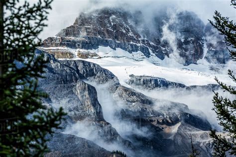 Fog On Snowy Mountain Range Stock Photo Dissolve