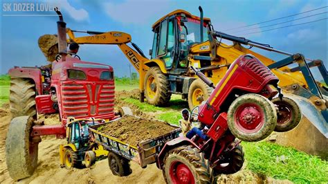 Jcb Dx Backhoe Machine Loading Mud In Mahindra Di Turbo Tractor