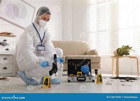 Investigator In Protective Suit Working At Crime Scene Indoors Stock