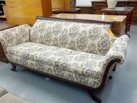 A Couch And Table In A Room With Other Furniture On The Floor At A Store