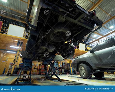 Car on Hydraulic Lift in Auto Repair Shop Stock Photo - Image of ...