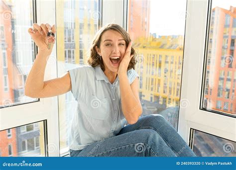 Happy Excited Woman Holding Keys In Hand And Feeling Overjoyed With