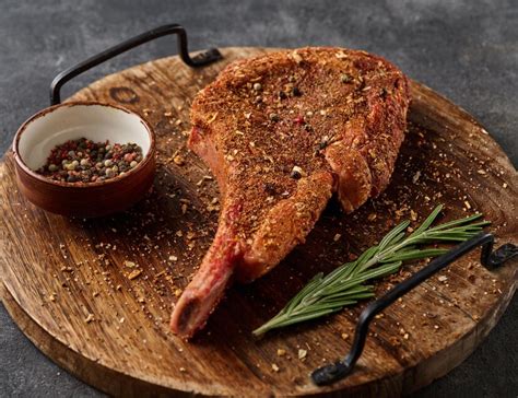 Premium Photo | Raw tomahawk steak in rub marinade for bbq