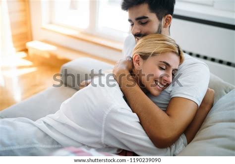 Стоковая фотография 1190239090 Cute Couple Hugging Smiling Their Home