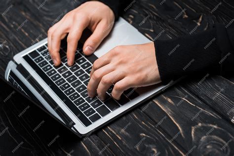 Premium Photo | Cropped view of hacker typing on laptop keyboard