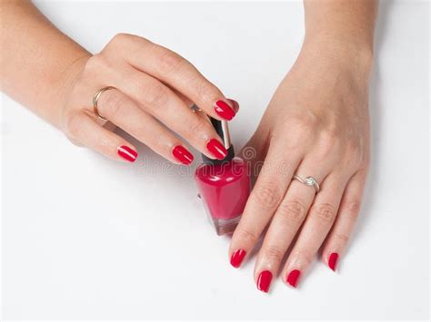 Woman S Hands With Red Manicure And A Bottle Of Nail Polish Stock Image