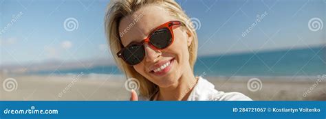 Smiling Woman Wearing Sunglasses Showing Thumbs Up Sign Taking Selfie