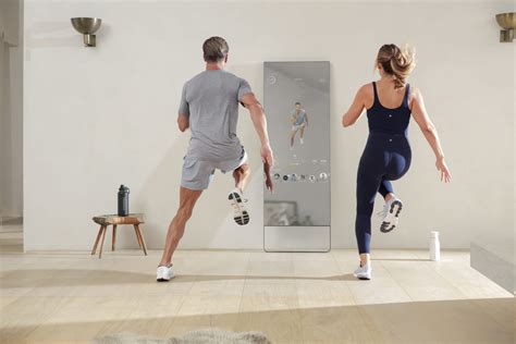 Man And Woman Running In Place In Front Of The Mirror At Home