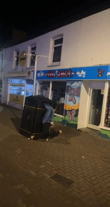 Guy Attempts To Jump Across Trash Can Ending Up Getting His Feet Stuck