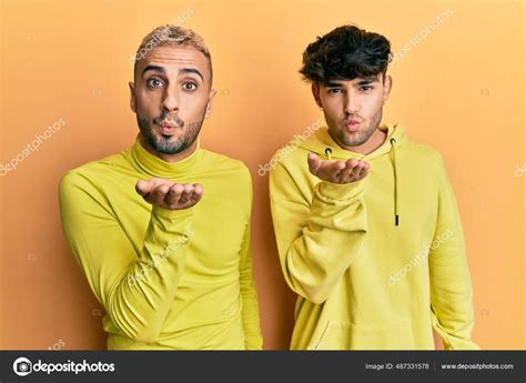 Homosexual Gay Couple Standing Together Wearing Yellow Clothes Looking Camera Stock Photo