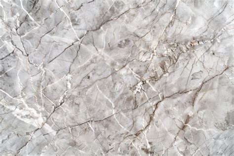 A white marble textured background with a pattern of white and silver ...