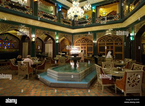 People sit in the Iranian Parisa restaurant located in Souq Waqif ...