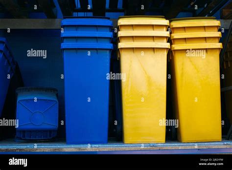 Paper and plastic recycle bins, yellow and blue Stock Photo - Alamy