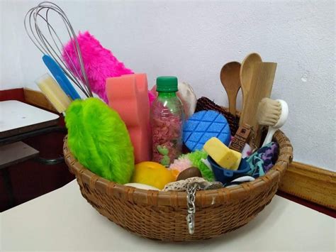 A Basket Filled With Lots Of Different Items On Top Of A White Table