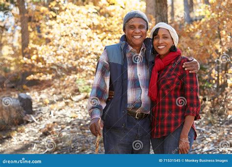 Senior African American Couple Walking Through Fall Woodland Stock