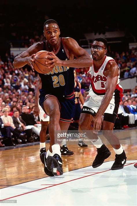 Laphonso Ellis of the Denver Nuggets drives against Buck Williams of...