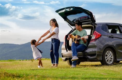 Premium Photo | Happy family by the car in the countryside