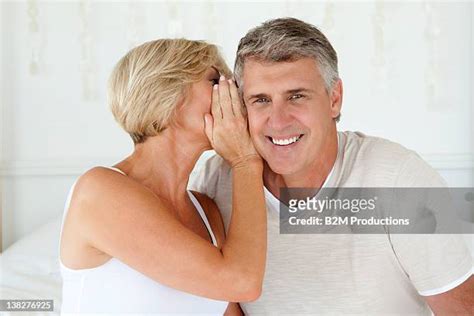 Couple Whispering In Ear Photos And Premium High Res Pictures Getty Images