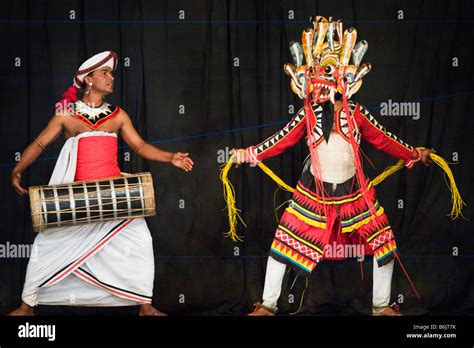 Kandyan Dancer In Mask And Costume Performing On Stage In Kandy Sri