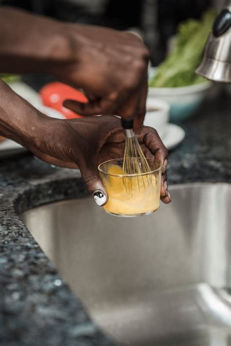 Person Holding Yellow Plastic Container · Free Stock Photo