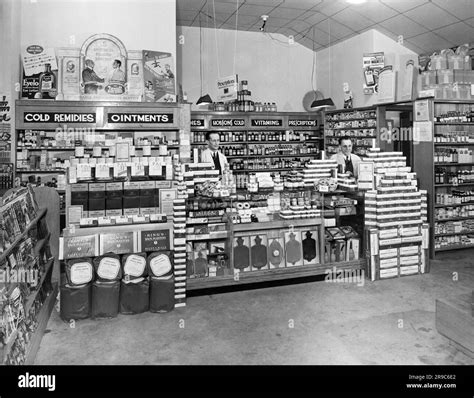 United States C 1943 Two Pharmacists Standing At Their Drugstore