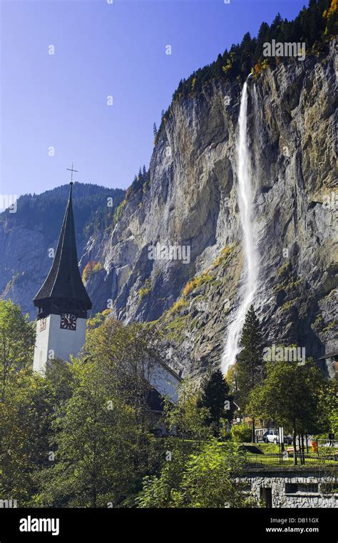 The Picture Shows A View Of A Church With The Staubbach Fall In The