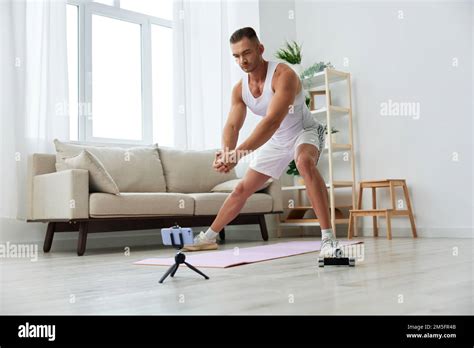 Man Sports Watching A Workout Tape On His Phone And Repeating