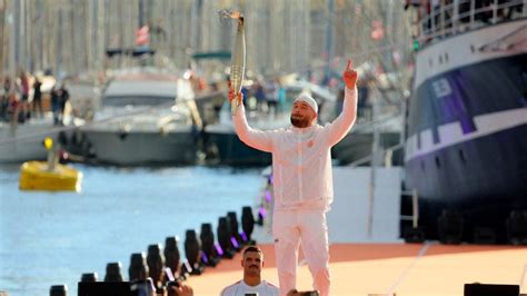 Watch Olympic Flame Arrives In France At Marseille Ahead Of Paris