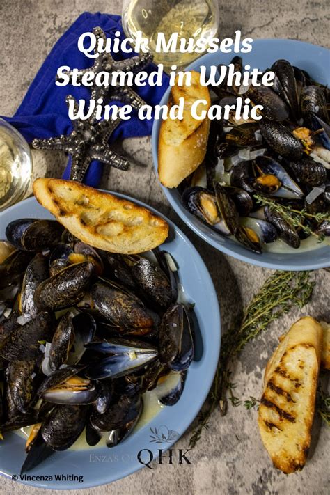 Two Bowls Of Steamed Mussels In White Wine And Garlic With Slices Of