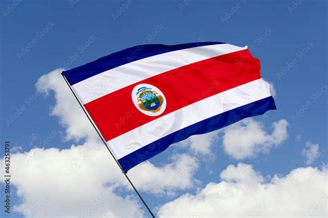 Costa Rica flag isolated on the blue sky background. close up waving ...